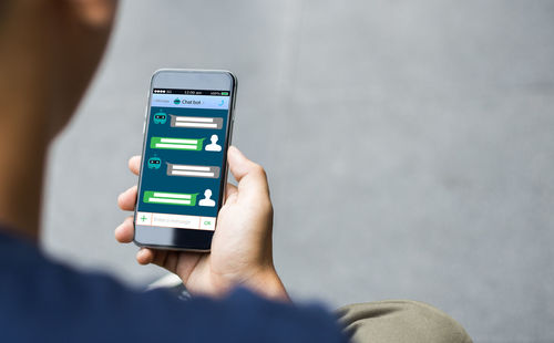 Close-up of man using mobile phone