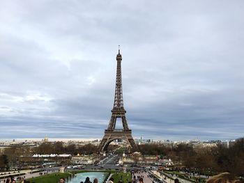 Eiffel tower against cloudy sky