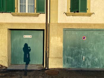 Silouette of woman standing by a wall