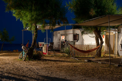 Evening view of a calm camping with caravans settled at the sea shose