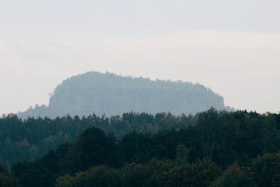 Scenic view of trees and mountains against sky