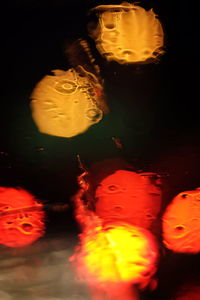 Close-up of lit candle in water