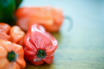 Close-up of red chili peppers on table