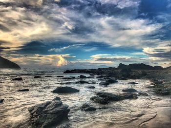 Scenic view of beach against sky during sunset