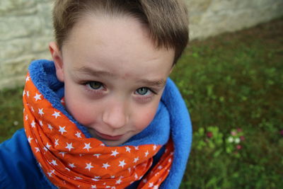 High angle portrait of boy standing on field