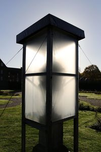 Close-up of built structure on field against sky