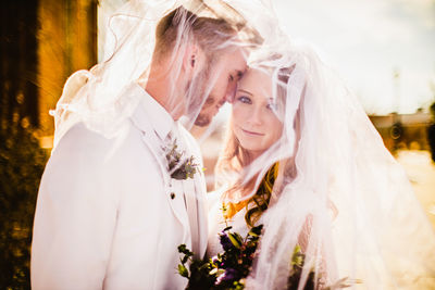 Close-up of couple holding bouquet