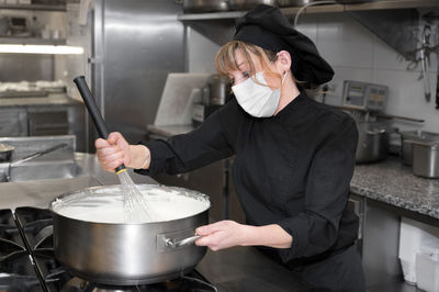 Midsection of man preparing food in kitchen