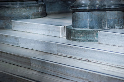 Grey stone pillars on stairs in a cathedral
