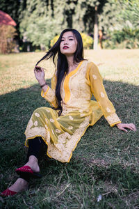 Young woman smiling while standing on field