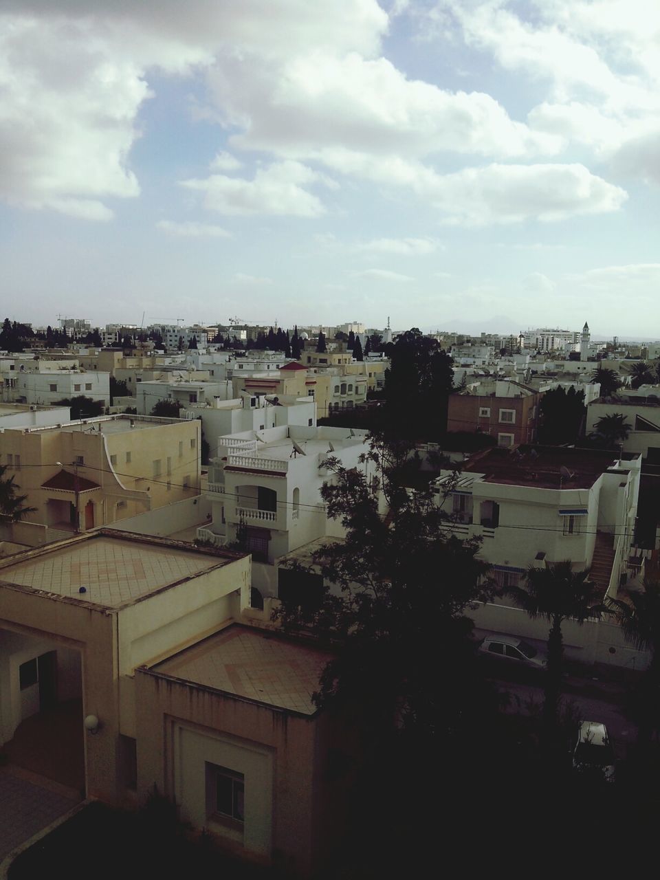 building exterior, architecture, built structure, cityscape, city, crowded, sky, residential district, high angle view, residential building, residential structure, cloud - sky, roof, house, town, townscape, cloudy, cloud, day, outdoors