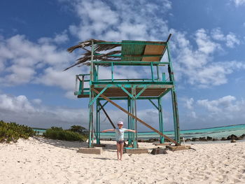 Lifeguard hut on beach against sky