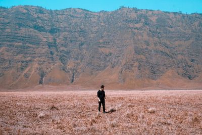 Rear view of man standing on field