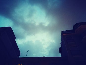 Low angle view of building against cloudy sky