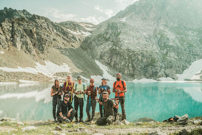 People standing by mountains