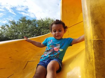 Low angle view of girl enjoying slide