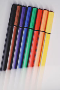 High angle view of multi colored pencils on white background