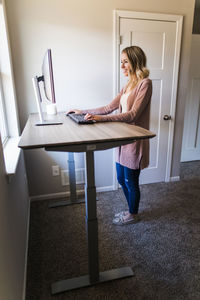 Woman using mobile phone at home