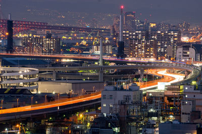 High angle view of illuminated cityscape against sky at night