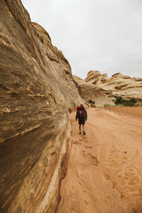 Rear view of men walking on rock