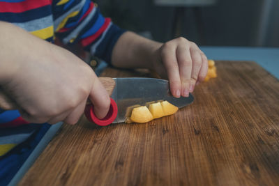 Midsection of person having food on table