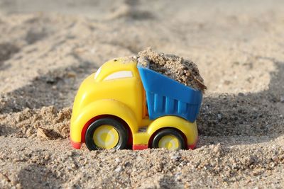 Close-up of toy car on sand