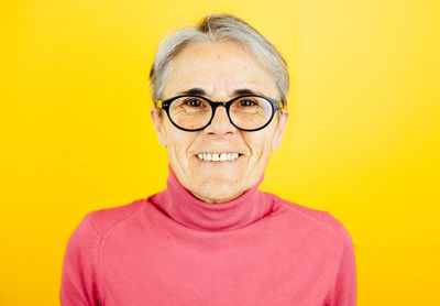 Portrait of young man against yellow background