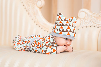 Cute boy lying on bed at home