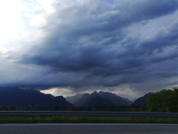 Scenic view of lake by mountains against sky