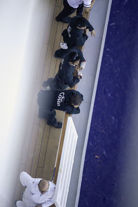 Low section of people standing on wall