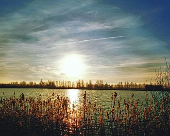 Scenic view of lake against sky during sunset