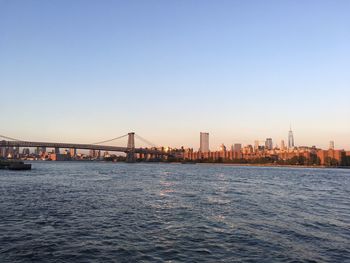 Williamsburg bridge and manhattan skyline  against clear sky