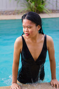 Close up view of sensuous asian woman standing in pool