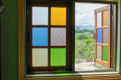 Plants seen through window of house