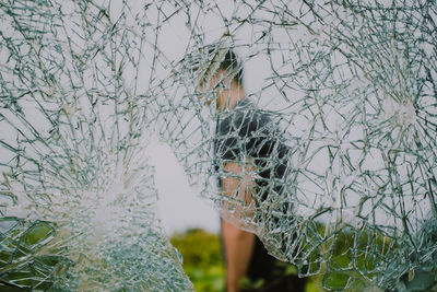 Man seem through shattered glass