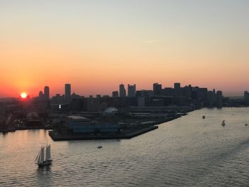 View of city at waterfront during sunset