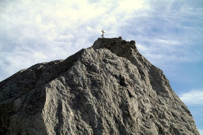 Low angle view of rock formations on mountain against sky