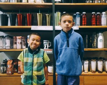 Portrait of father with son standing in store