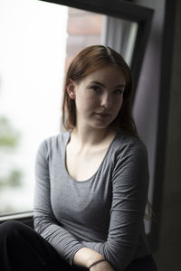 Portrait of woman sitting at home