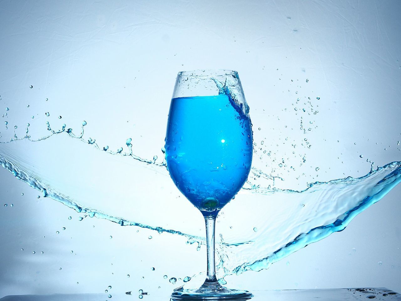 CLOSE-UP OF WINE AGAINST BLUE BACKGROUND