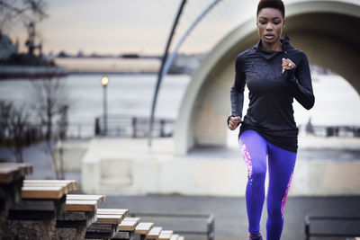 Determined female athlete running at stadium