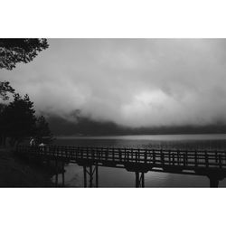 Scenic view of river against cloudy sky