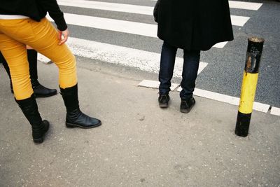 Low section of people walking on road