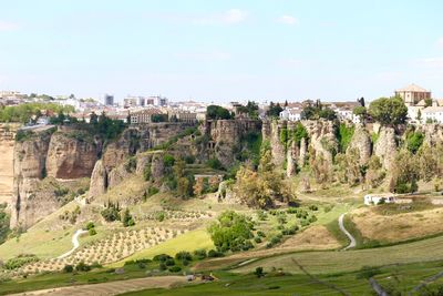 Buildings on cliff by field