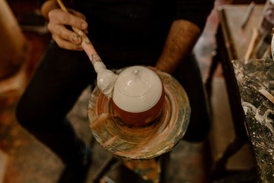 Cropped hand of man preparing food