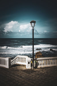 Lifeguard hut on beach against sky