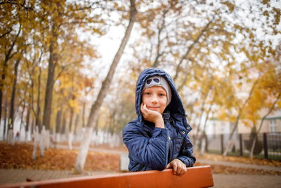 Portrait of young woman sitting in park