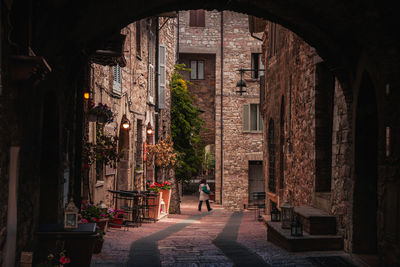 Narrow street amidst buildings in city at night