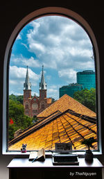 View of buildings against cloudy sky