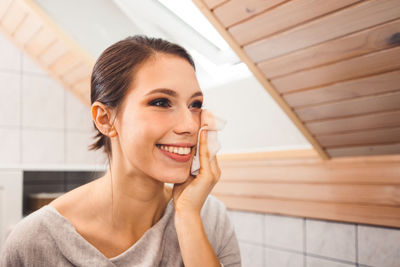 Portrait of young woman sitting at home